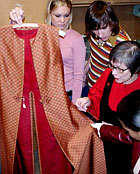 Professor Jane 
Farrell-Beck shows students pieces in the textiles collection.